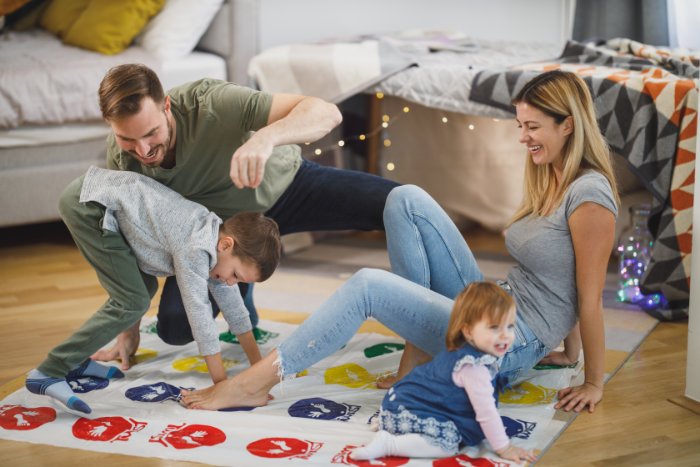 adults and children playing twister